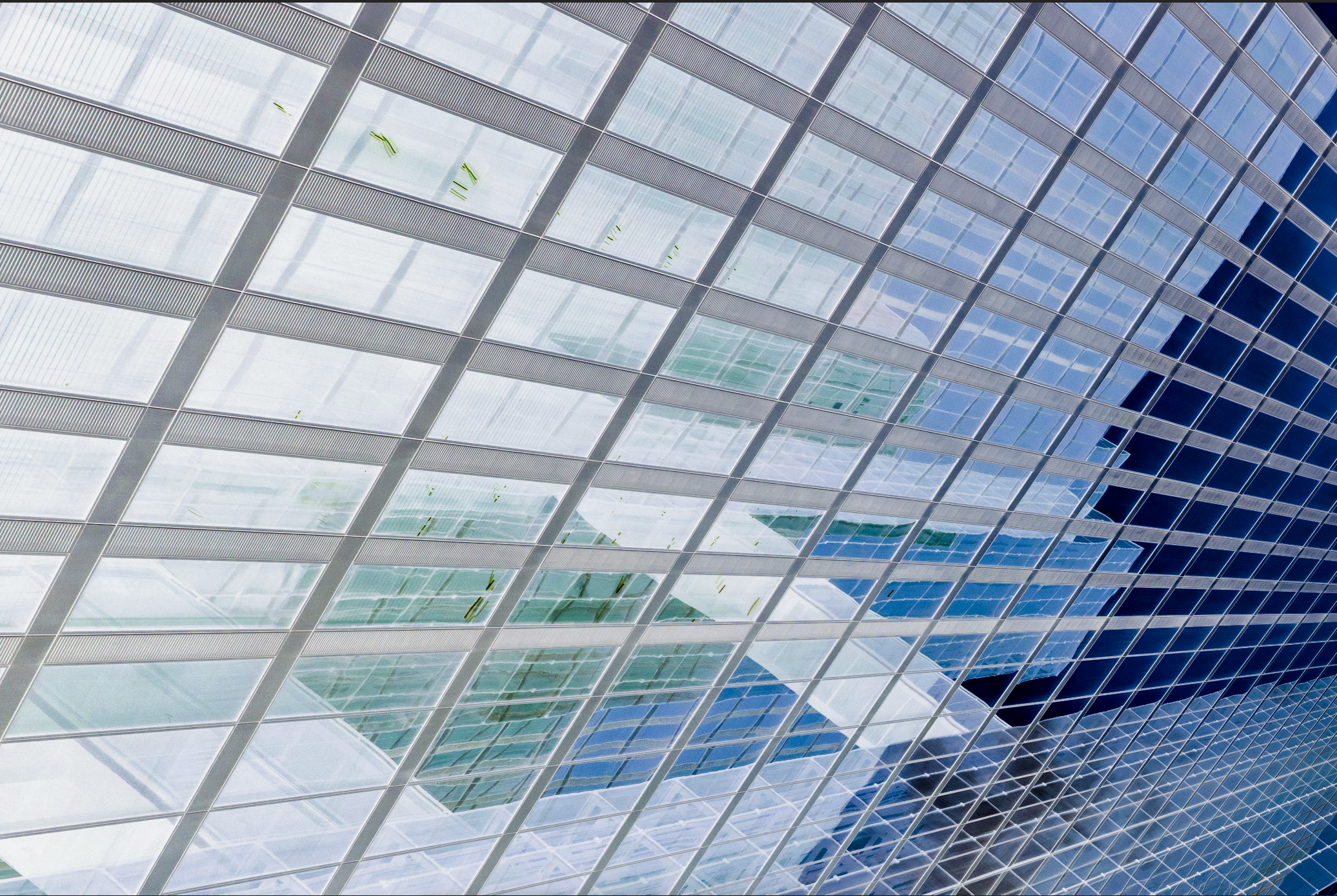 A grid of glass panels on a contemporary Munich building façade, Germany — modern architectural photography